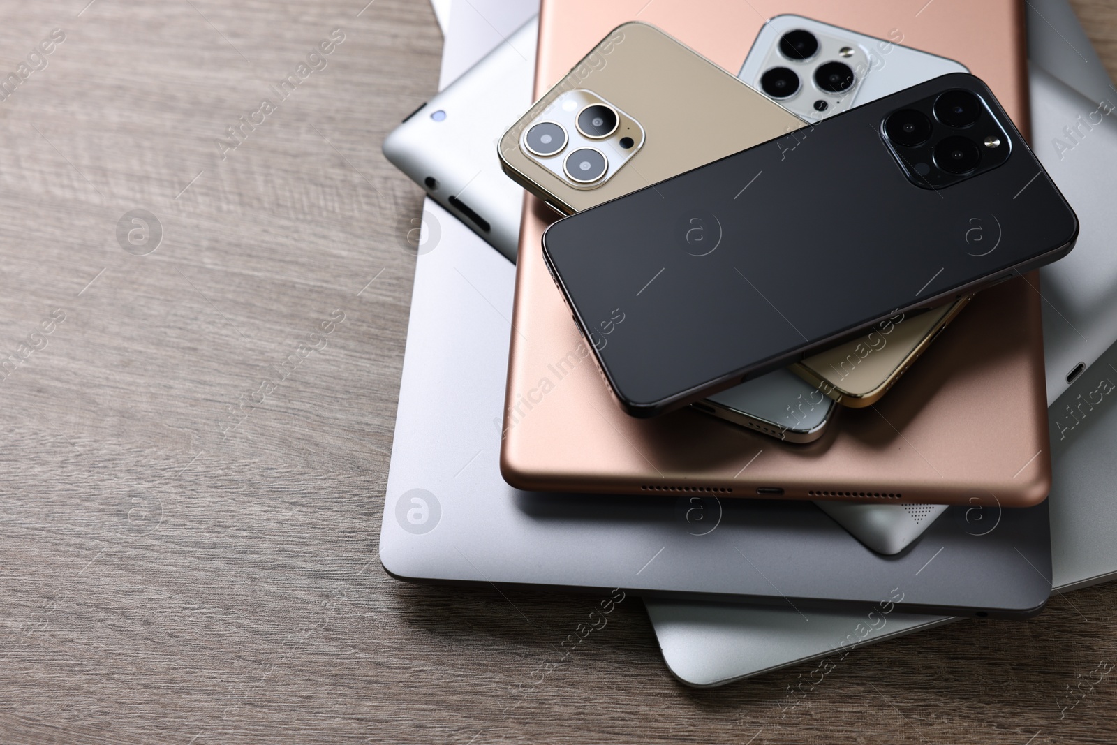 Photo of Many different modern gadgets on wooden table, space for text