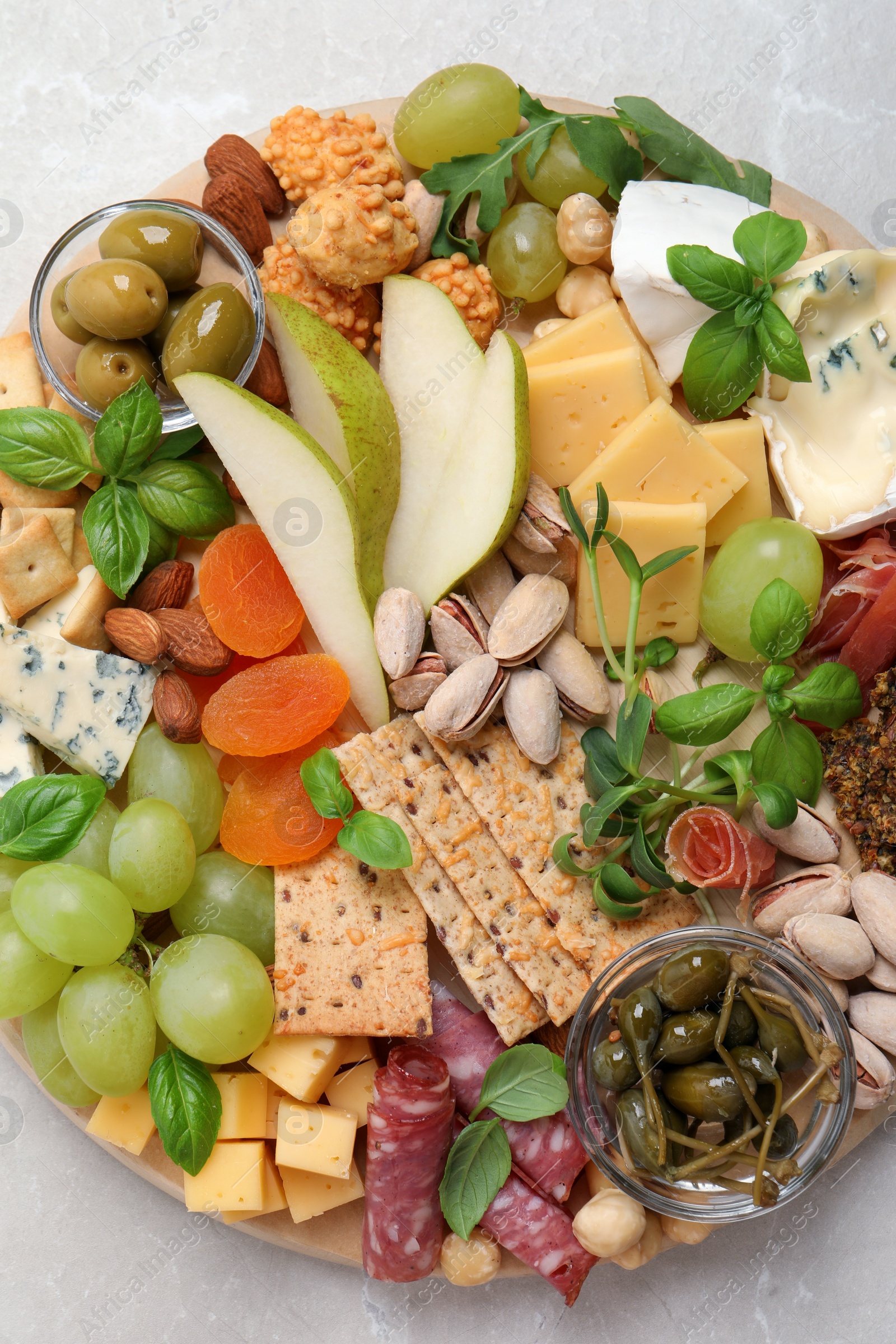 Photo of Different tasty appetizers on light table, top view