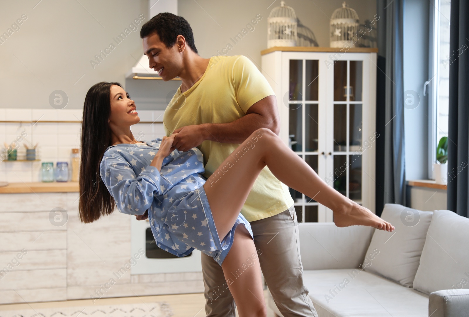 Photo of Lovely young interracial couple dancing at home