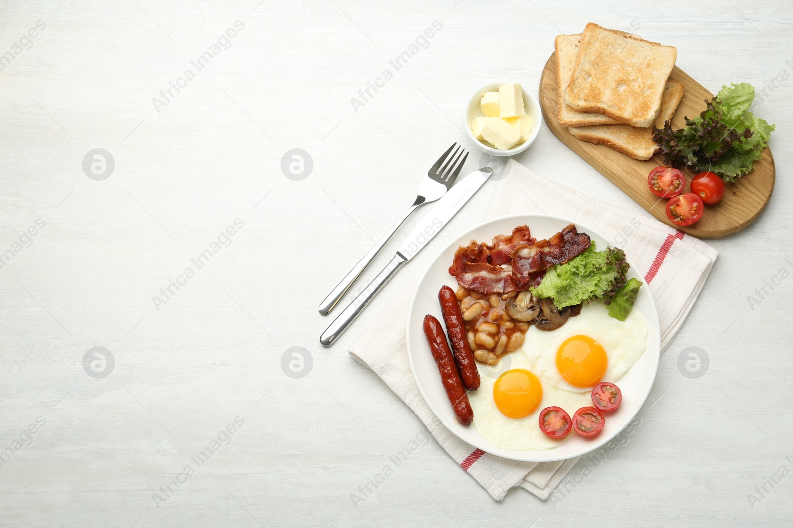 Photo of Delicious breakfast with sunny side up eggs served on white table, flat lay. Space for text