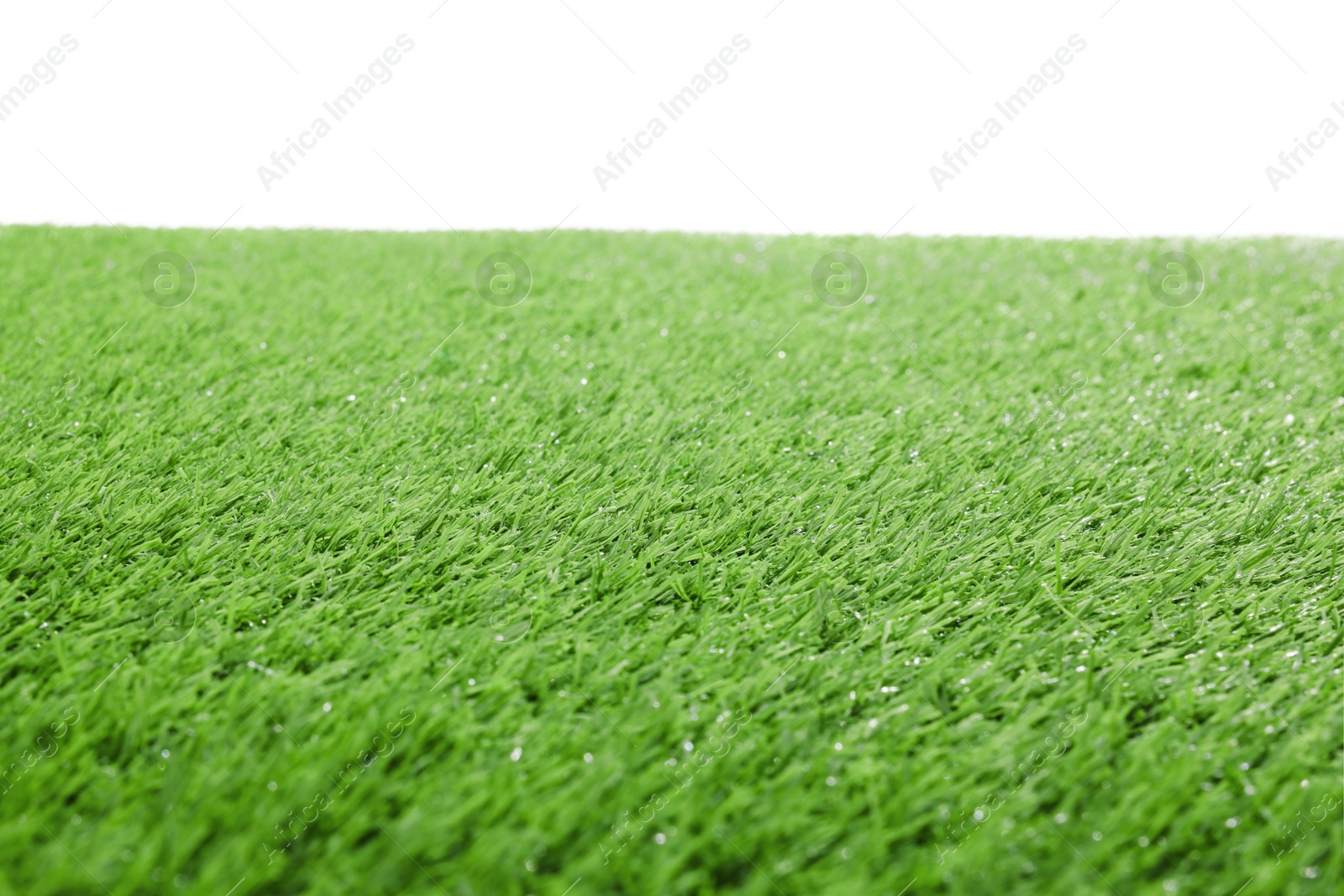 Photo of Green artificial grass surface isolated on white