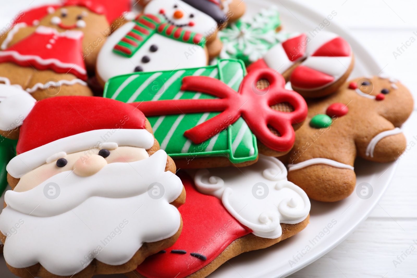 Photo of Delicious Christmas cookies on plate, closeup view