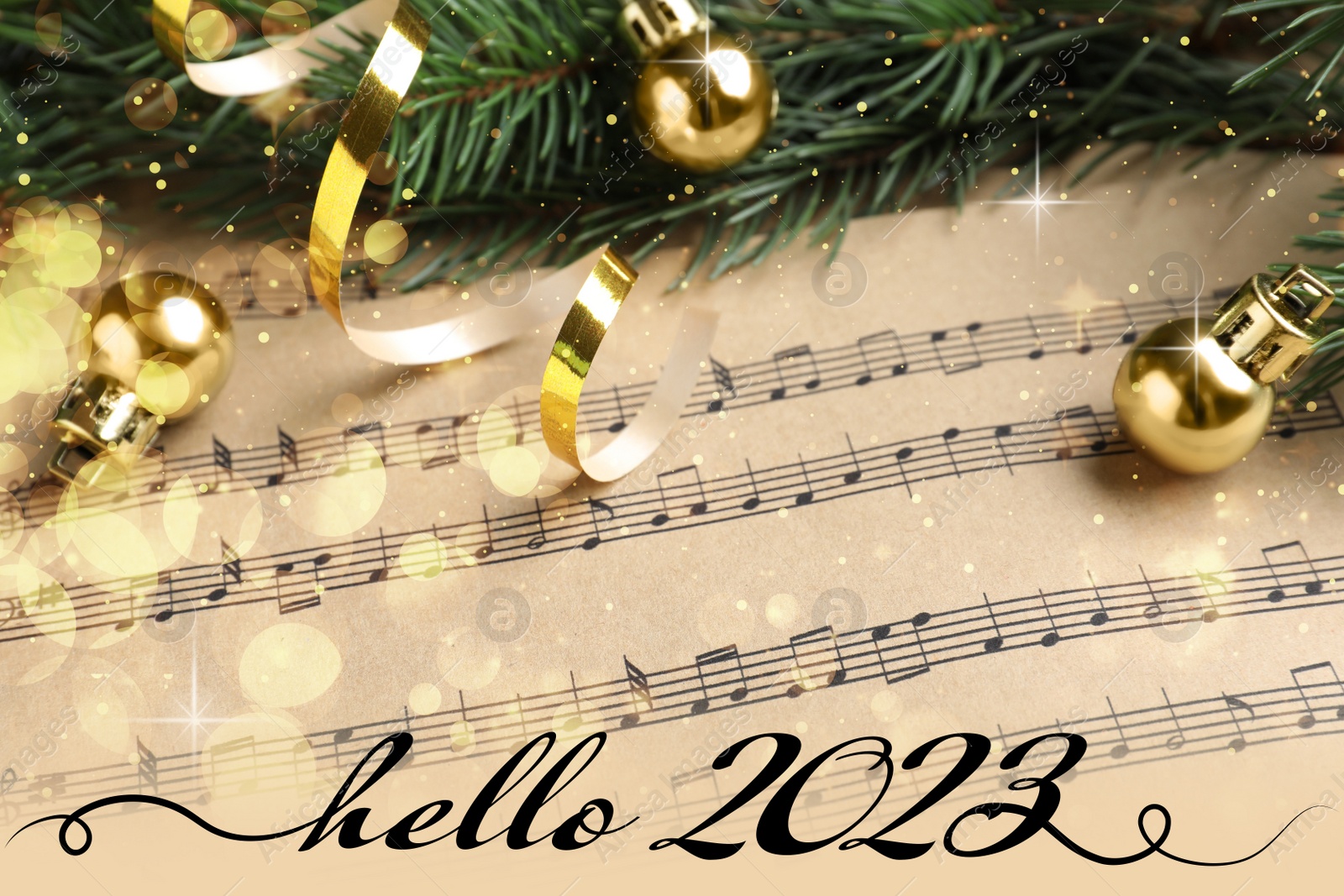 Image of Hello 2023. Fir branches and golden balls on Christmas music sheets, above view