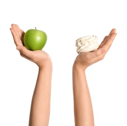 Photo of Concept of choice. Woman holding apple and zephyr on white background, closeup