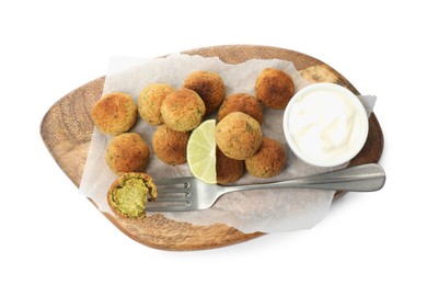 Delicious falafel balls with lime and sauce on white background, top view