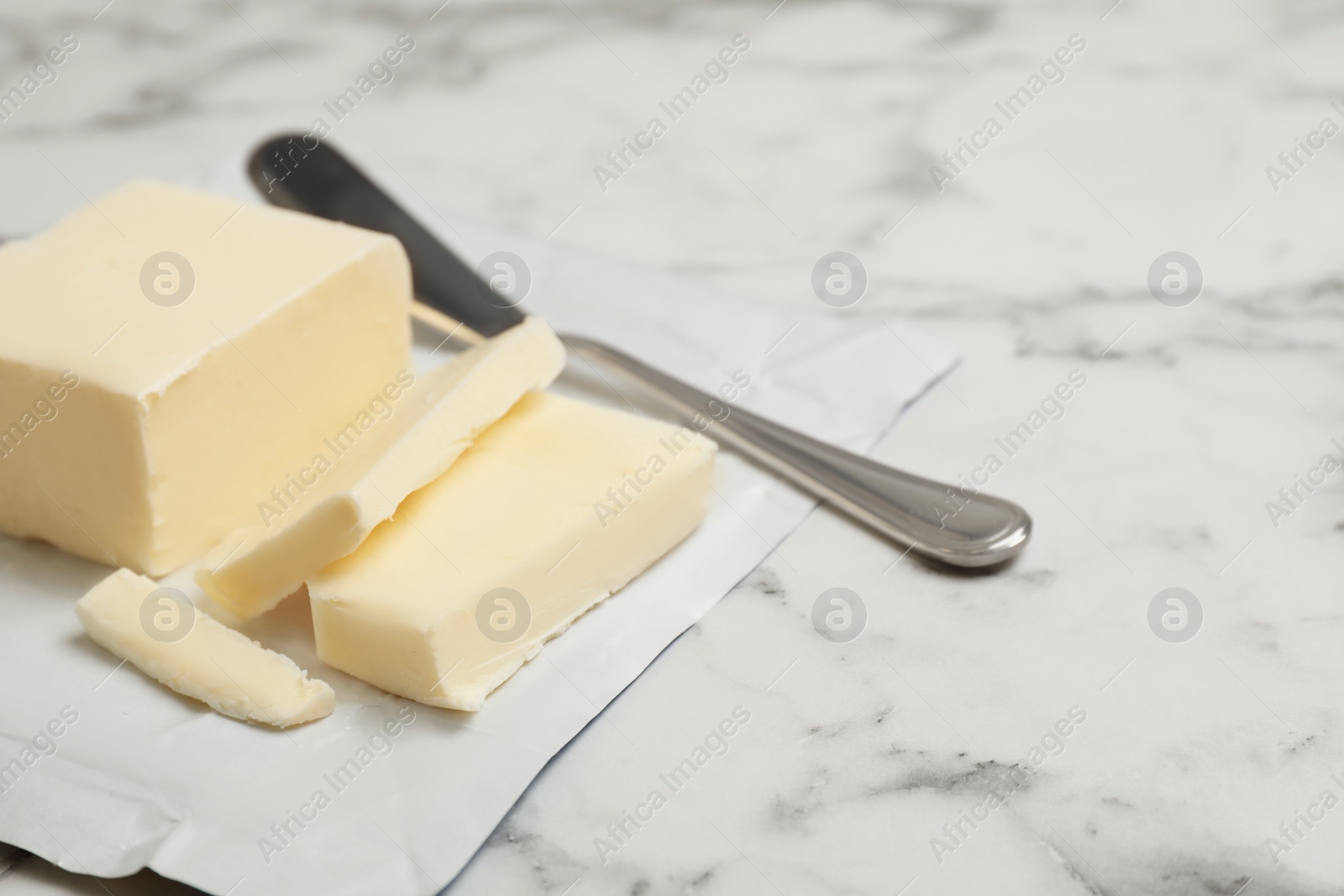 Photo of Tasty fresh butter and knife on table