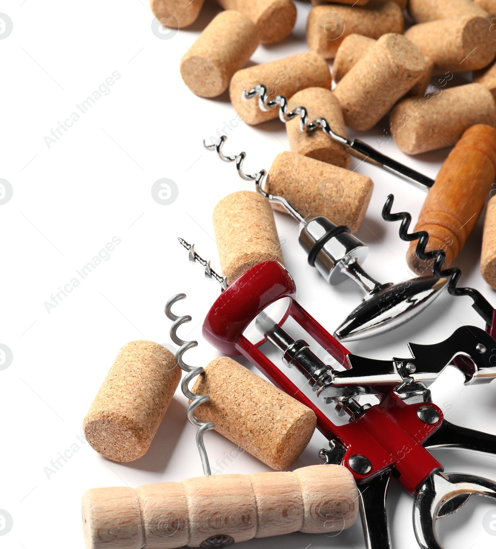 Photo of Different corkscrews and wine bottle stoppers on white background