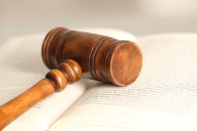 Photo of Law concept. Wooden gavel and book, closeup