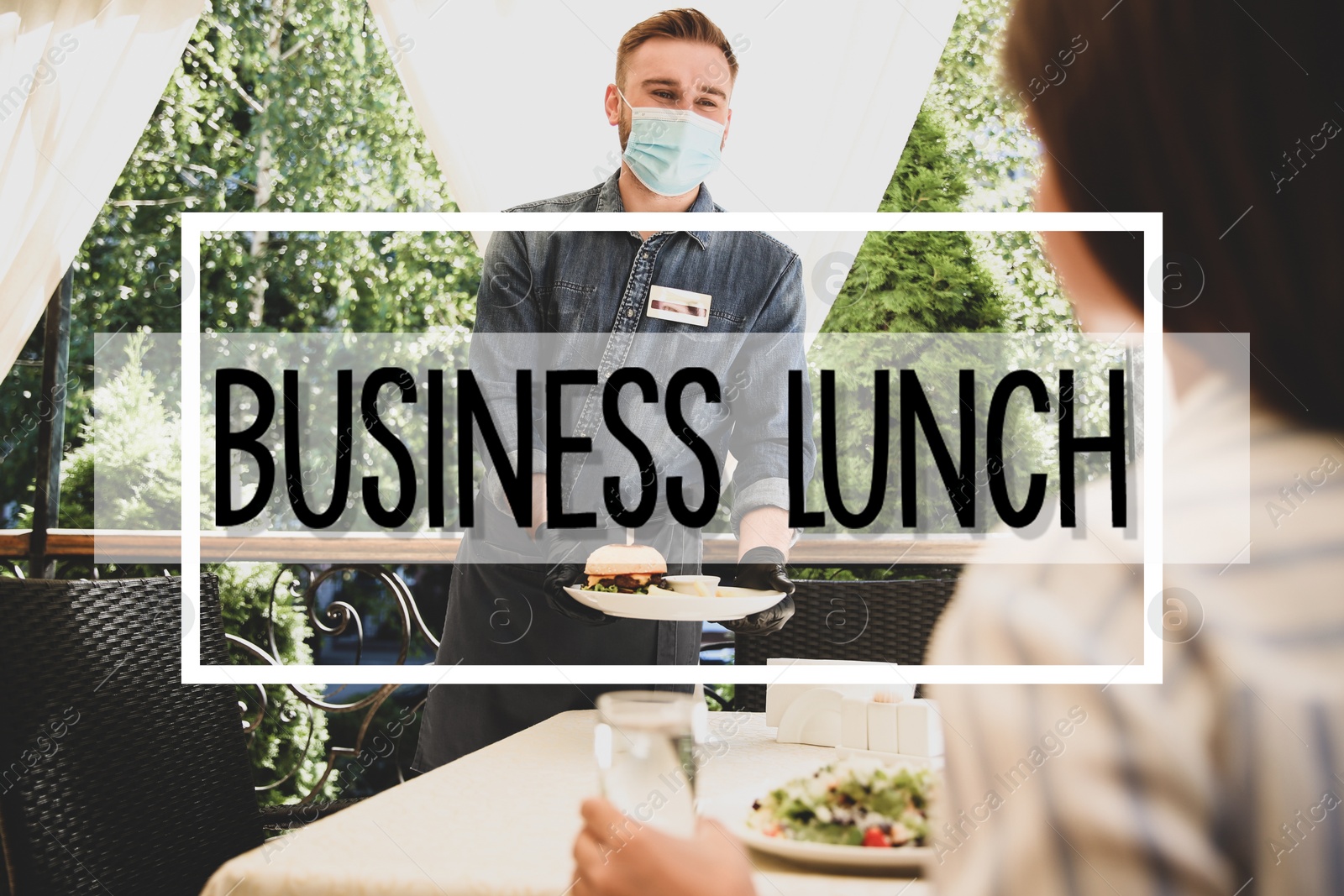 Image of Waiter serving food to customer in restaurant. Business lunch