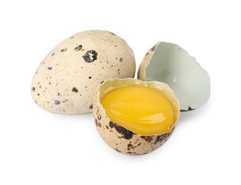 Photo of Whole and cracked quail eggs on white background