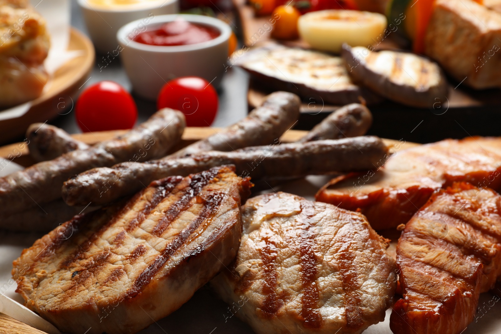 Photo of Barbecued meat and vegetables on table, closeup