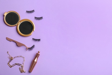 Flat lay composition with magnetic eyelashes and accessories on violet background. Space for text