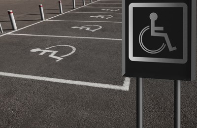 Image of Sign with wheelchair symbol near car parking, space for text 