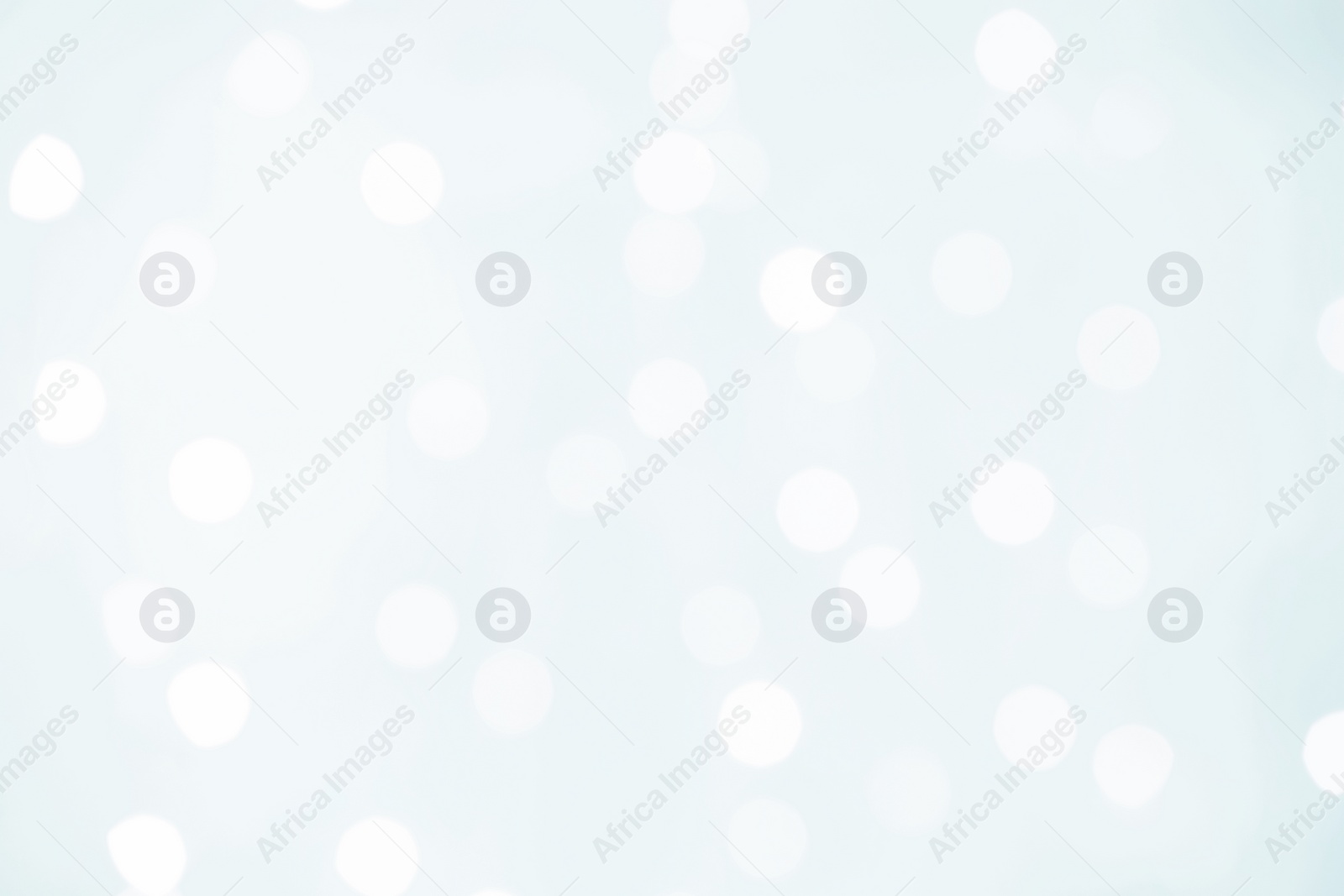 Image of Blurred view of festive lights on white background. Bokeh effect