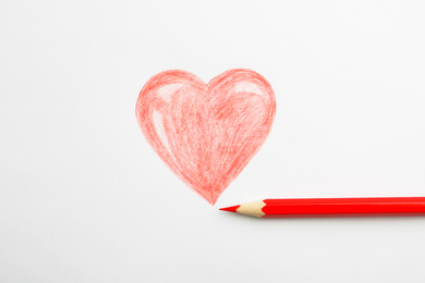 Photo of Drawing of heart and red pencil on white background, top view