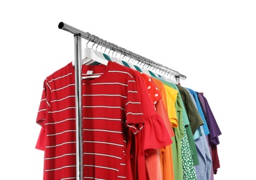 Photo of Wardrobe rack with different colorful clothes on white background