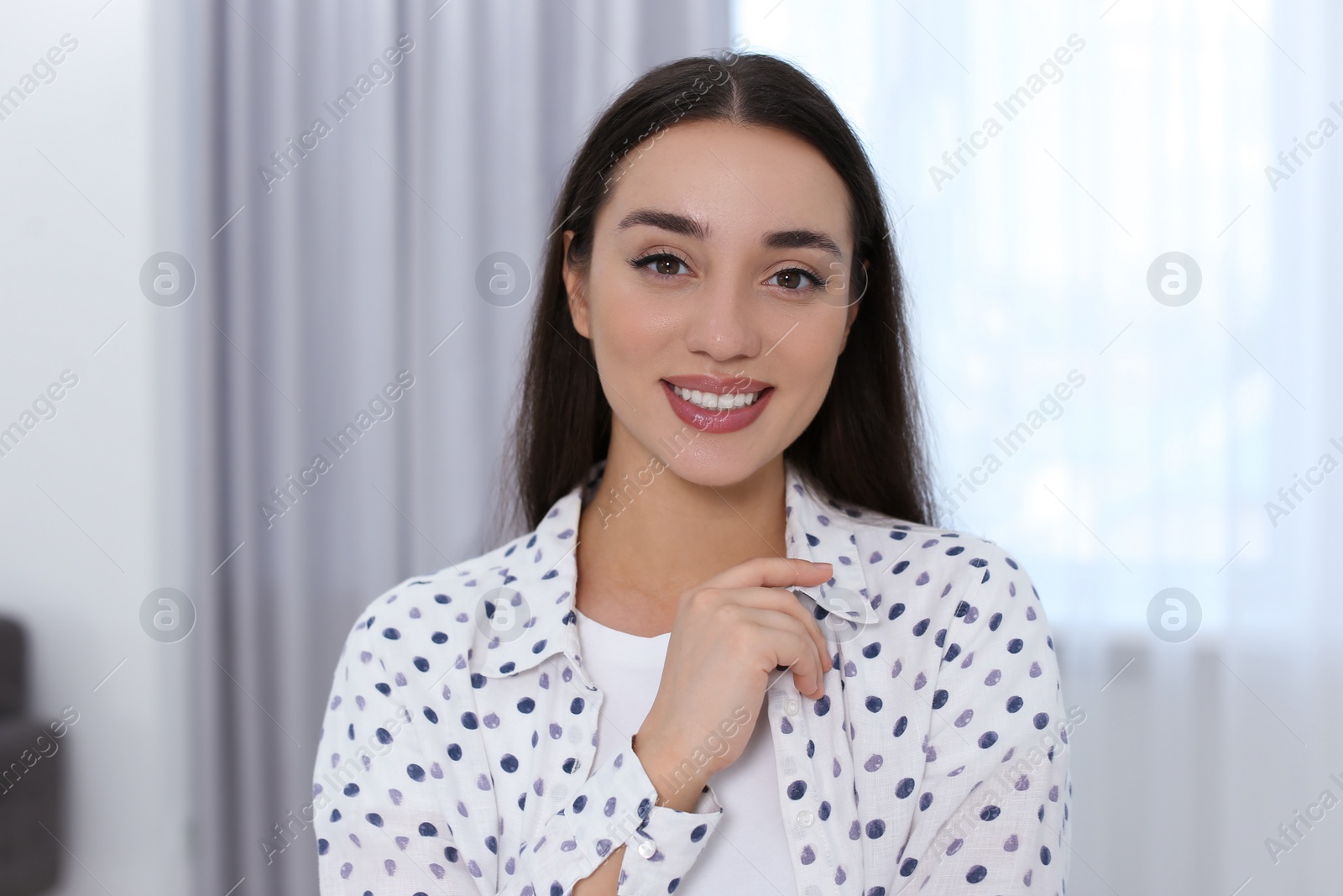 Photo of Portrait of beautiful young woman at home