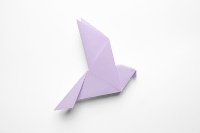 Photo of Beautiful origami bird on white background, top view
