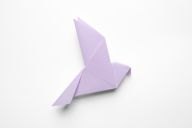 Beautiful origami bird on white background, top view