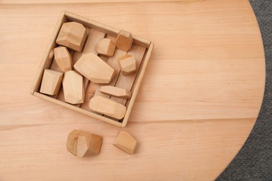 Photo of Set of wooden balancing stones on table, top view with space for text. Montessori toy