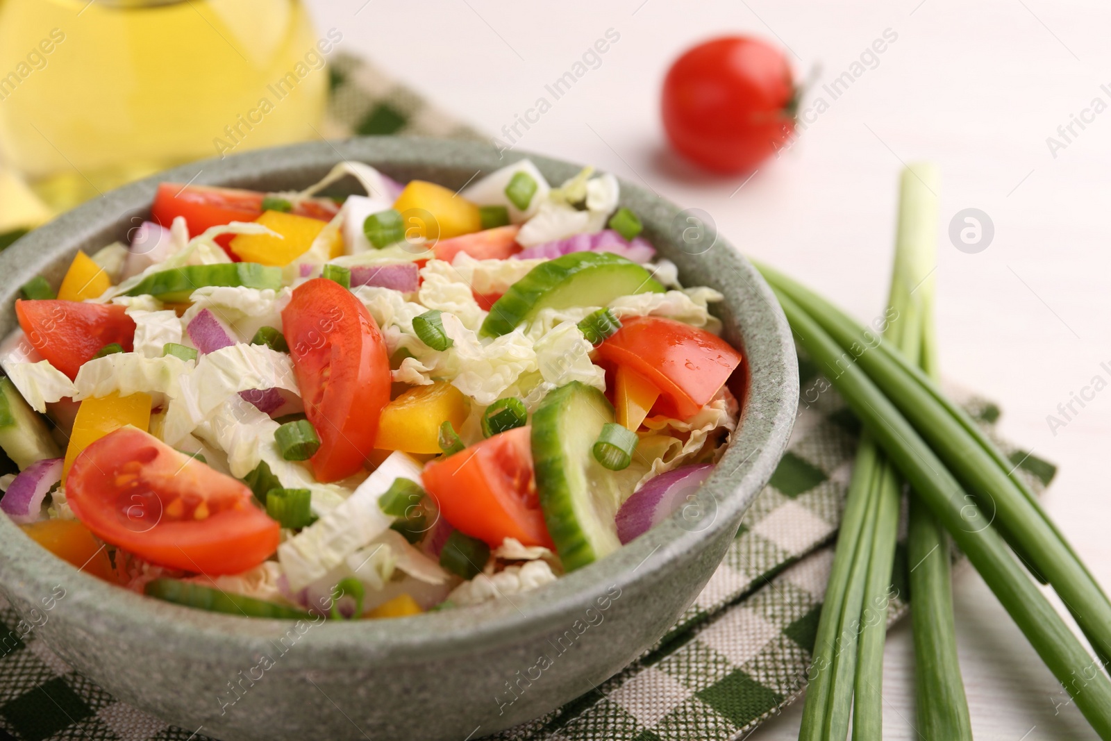 Photo of Tasty salad with Chinese cabbage in bowl on table, closeup