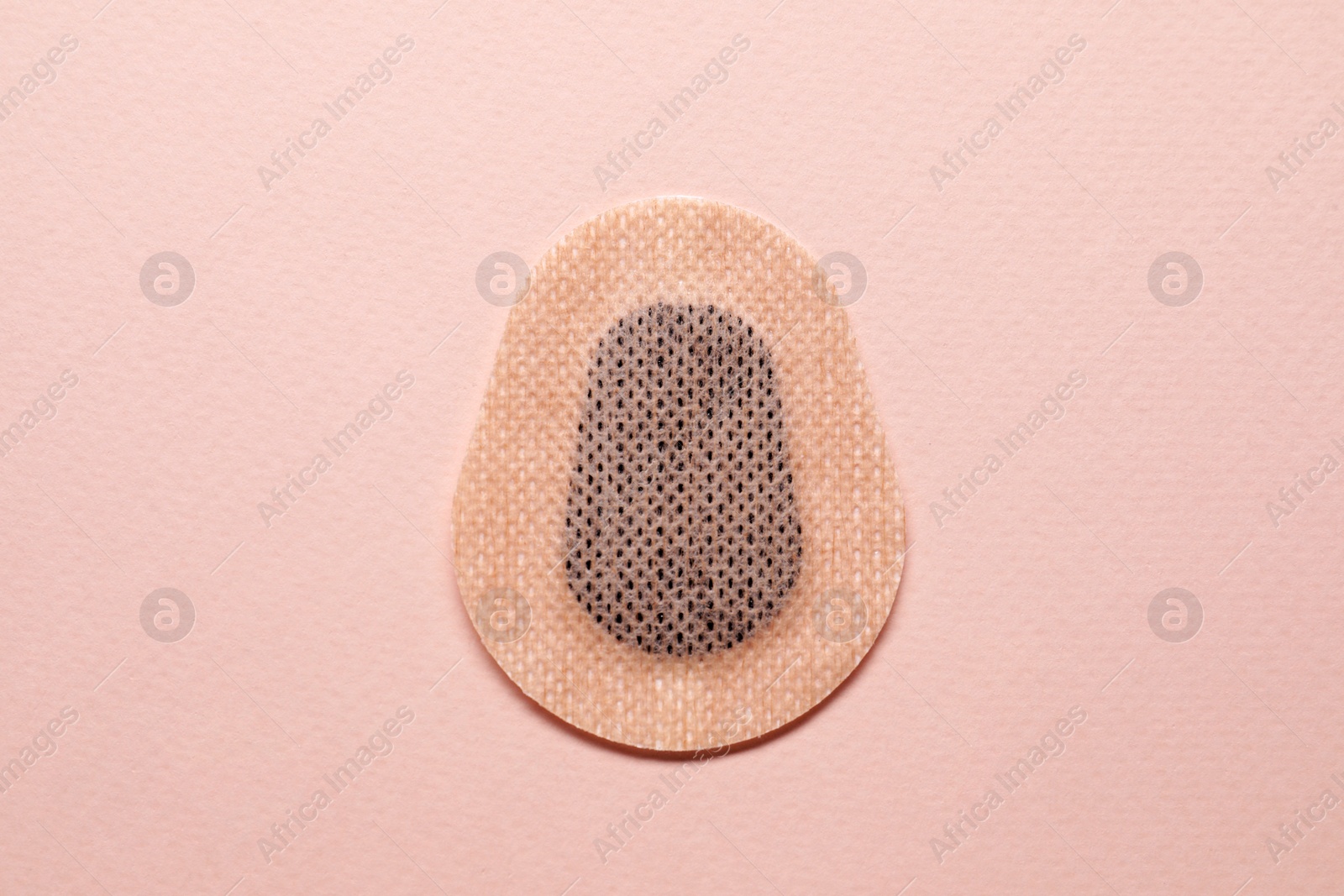 Photo of Contraceptive patch on pink background, top view