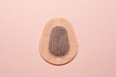 Photo of Contraceptive patch on pink background, top view