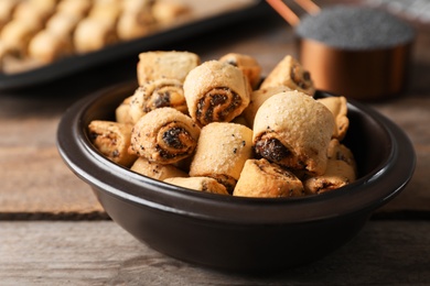 Photo of Tasty sweet cookies with poppy seeds on wooden table