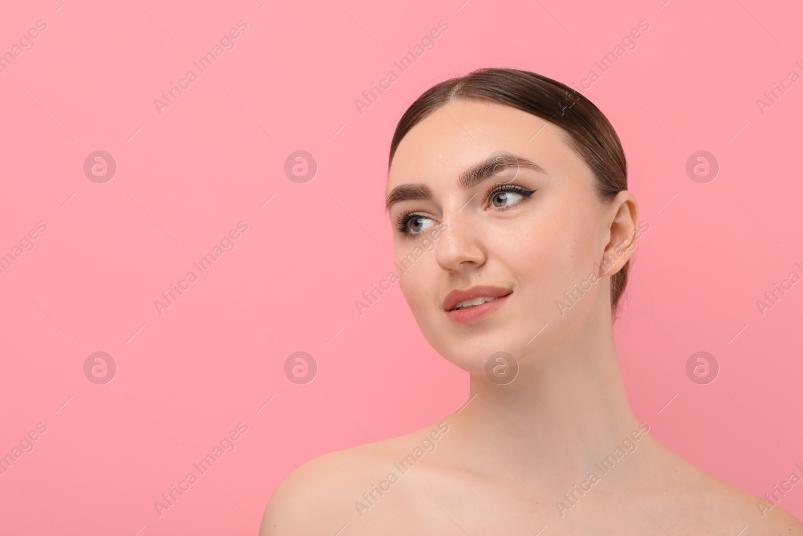 Photo of Makeup product. Woman with black eyeliner and beautiful eyebrows on pink background, space for text