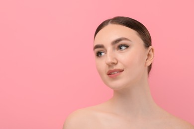 Makeup product. Woman with black eyeliner and beautiful eyebrows on pink background, space for text