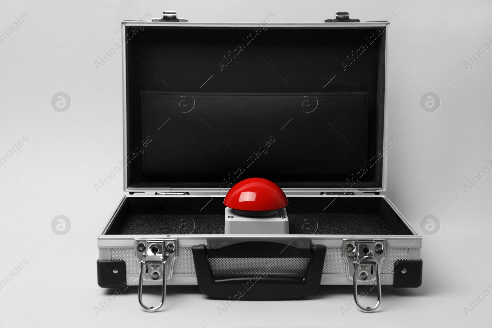 Photo of Red button of nuclear weapon in suitcase on white background. War concept