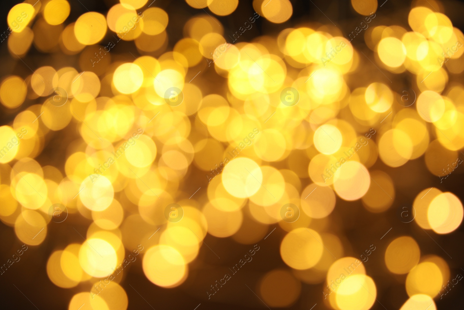 Photo of Gold glitter with bokeh effect on dark background