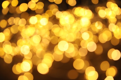 Photo of Gold glitter with bokeh effect on dark background