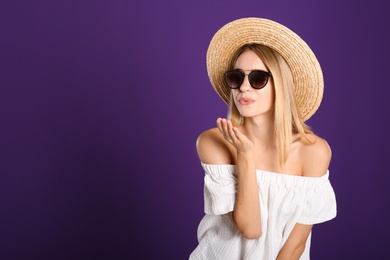 Photo of Beautiful woman in stylish sunglasses on purple background. Space for text