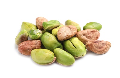 Photo of Heap of peeled organic pistachio nuts on white background, closeup