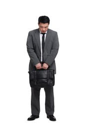 Tired businessman with briefcase posing on white background