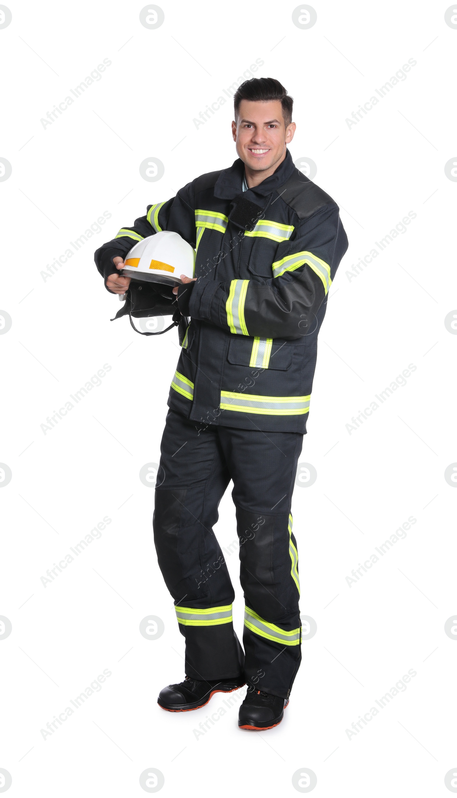 Photo of Full length portrait of firefighter in uniform with helmet on white background