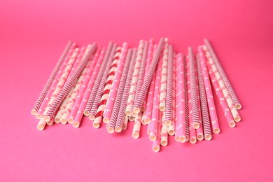 Photo of Many paper drinking straws on pink background