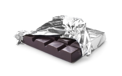 Photo of Delicious dark chocolate bar wrapped in foil isolated on white