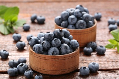 Tasty fresh blueberries on wooden table, closeup