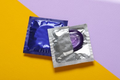 Condoms on color background, top view. Safe sex