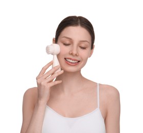 Washing face. Young woman with cleansing brush on white background