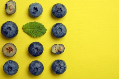 Photo of Flat lay composition with tasty blueberry and space for text on color background