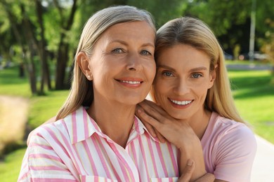 Photo of Family portrait of mother and daughter in park