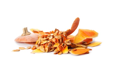 Photo of Pumpkin peel and seeds on white background. Composting of organic waste