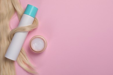 Photo of Lock of healthy blond hair and cosmetic products on pink background, flat lay. Space for text