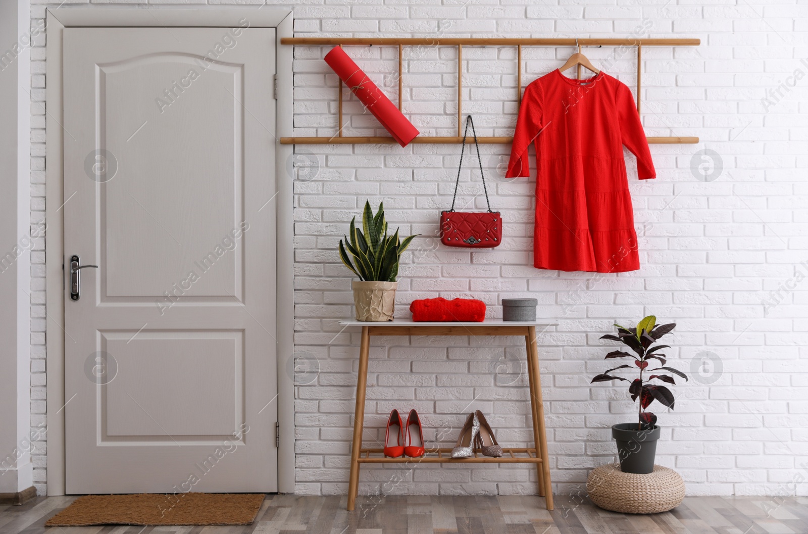 Photo of Hallway interior with stylish furniture, shoes and plants