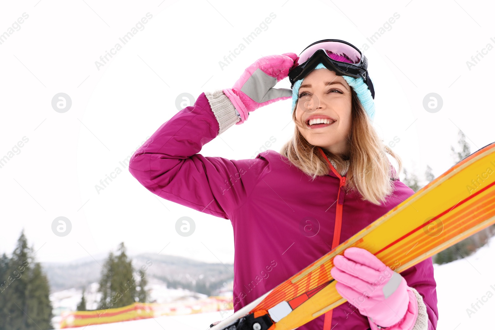 Photo of Female skier on slope at resort. Winter vacation