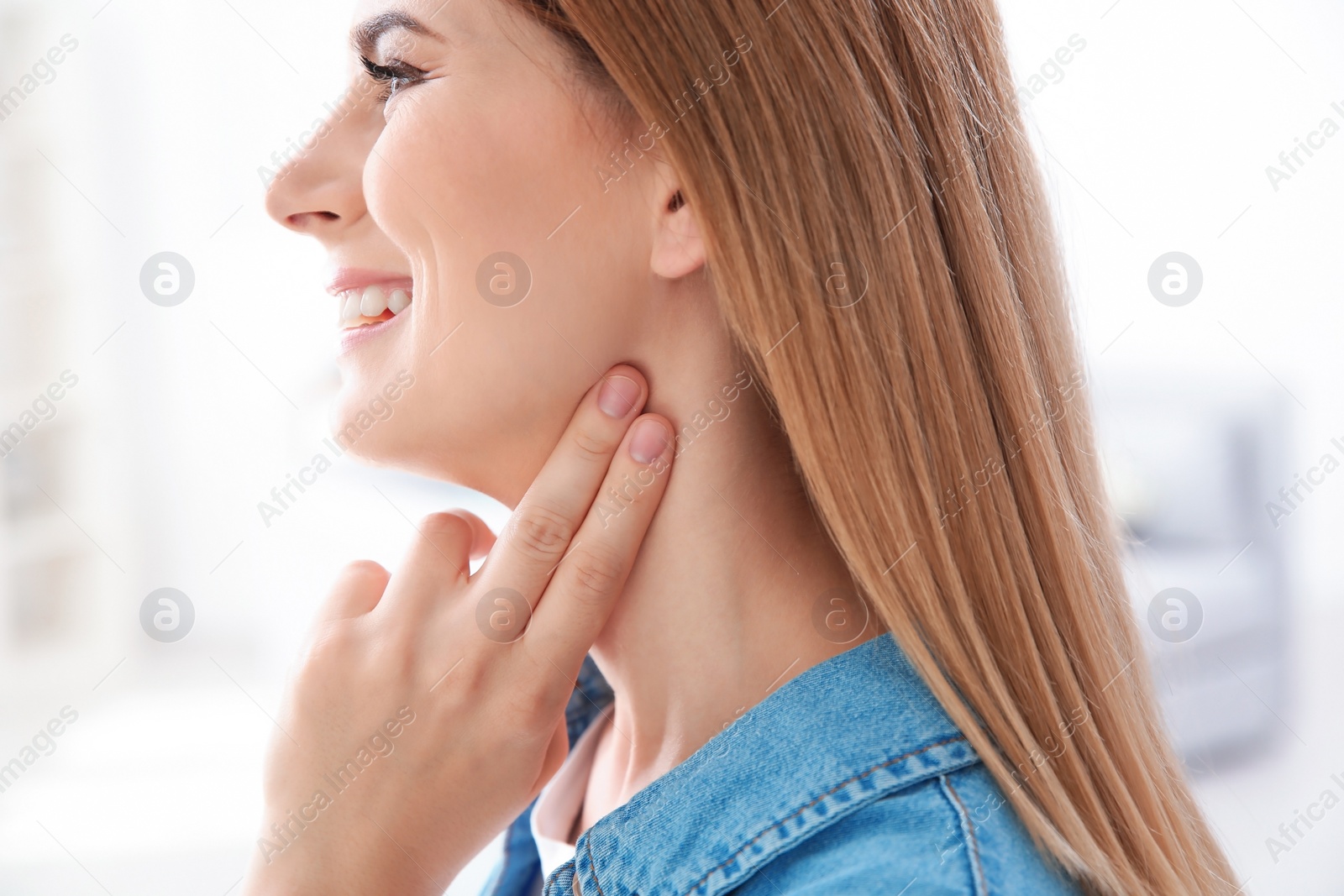 Photo of Young woman checking pulse on blurred background