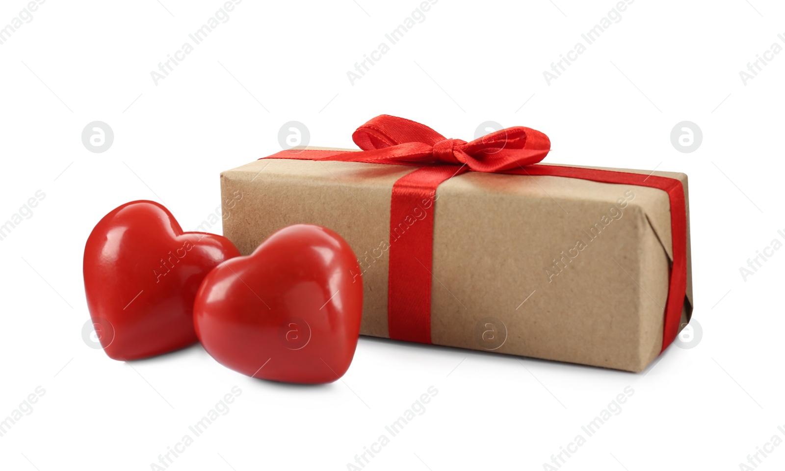 Photo of Beautiful gift box with red bow and decorative hearts on white background